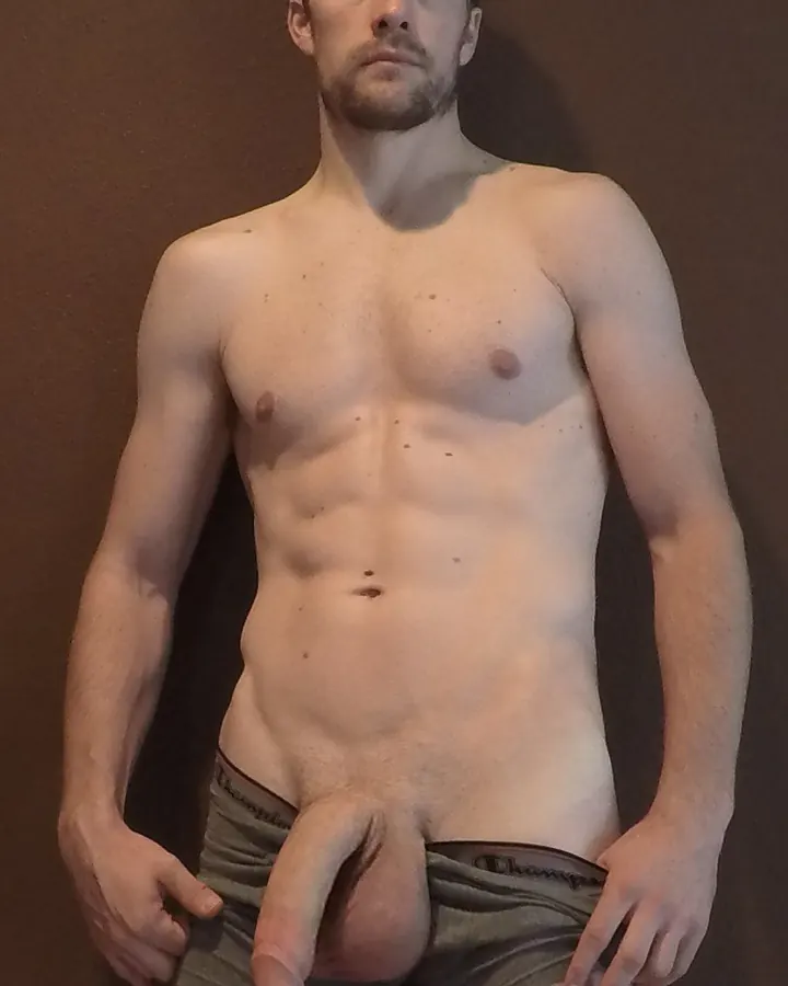 Homme torse nu, regardant l’appareil, mains sur les hanches, sous-vêtements Champion