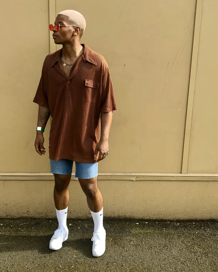 Homme africain torse nu, musclé, en sous-vêtements noirs, posant devant un fond blanc.